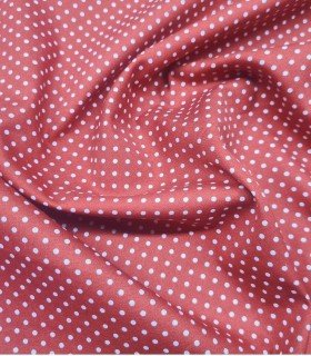 White polka dot fabric light maroon background